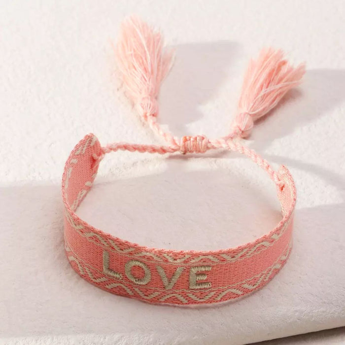 Love Bracelet
Handmade adjustable bracelet with woven letter embroidery. 
Love Bracelet