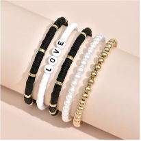 Stacked Bracelet Set - LOVE
Five-piece elastic bracelet set with clay beads, acrylic beads and gold plating.Stacked Bracelet Set - LOVE