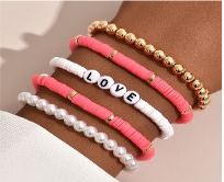 Stacked Bracelet Set - LOVE
Five-piece elastic bracelet set with clay beads, acrylic beads and gold plating.Stacked Bracelet Set - LOVE