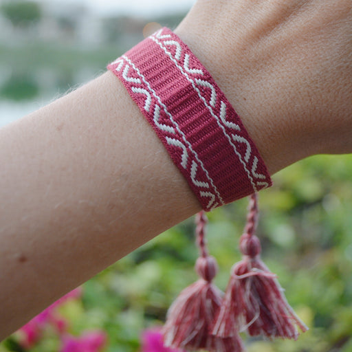 Pink Woven BraceletHandmade, adjustable tassel bracelet in pink / magenta and white.Pink Woven Bracelet