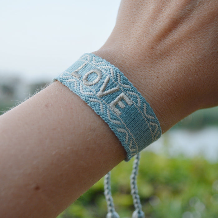 Love Bracelet
Handmade adjustable bracelet with woven letter embroidery. 
Love Bracelet